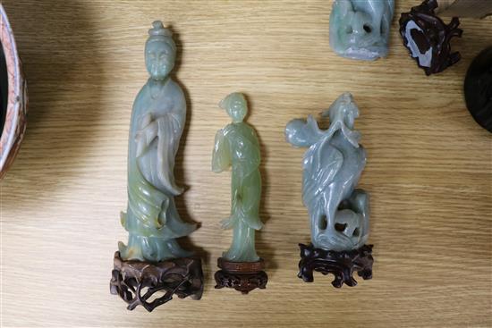 A Chinese celadon jade magnolia blossom, a jadeite figure of Guanyin, a pair of jadeite birds, a large soapstone figure of a lady and a